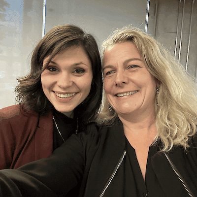 Selfie of Emma and Sarah, two women smiling closely together indoors