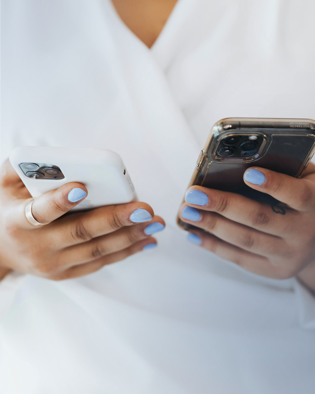 Close-up of two people's hands holding smartphones